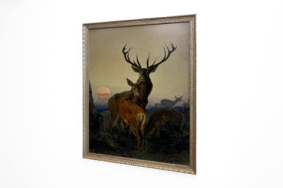 A Stag with a Deer in a Wooded Landscape at Sunset