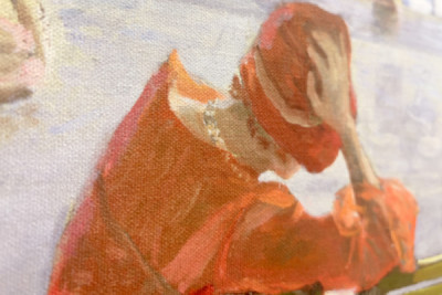 Girl in a red dress reading by a swimming pool