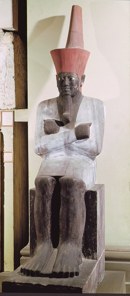 Statue of Mentuhotep II, enthroned and wearing the red crown of Lower Egypt, taken from the Mortuary Temple of Mentuhotep II, at Deir el-Bahri, Middle Kingdom, painted sandstone by Egyptian 11th Dynasty