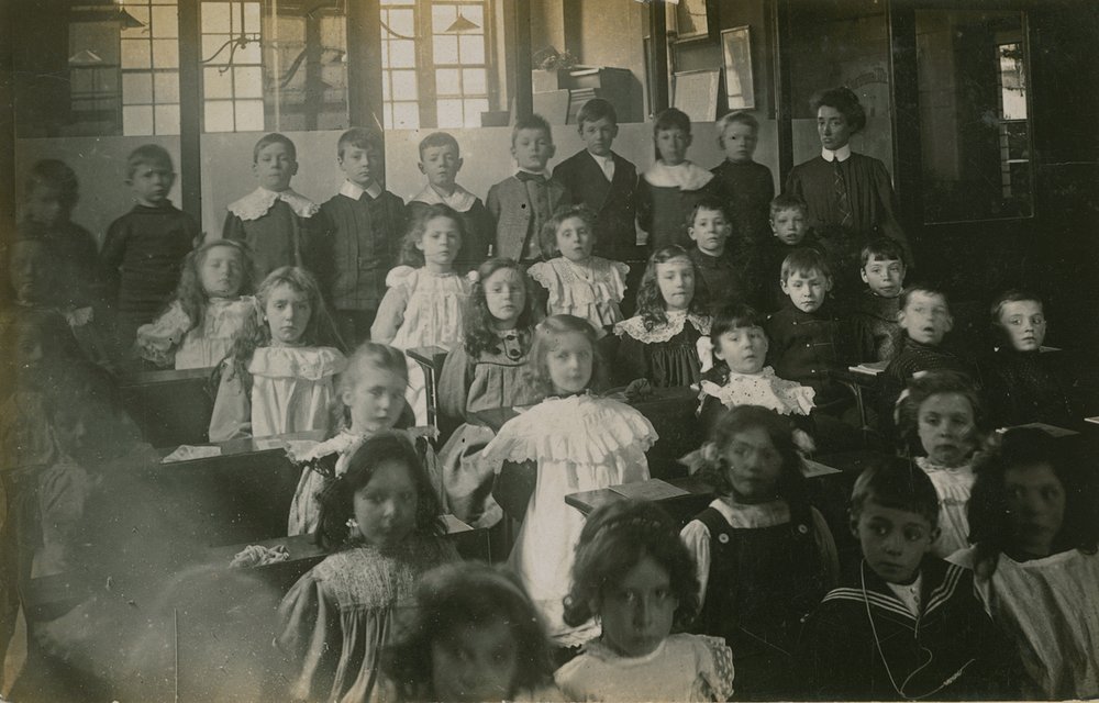 Pupils Sitting Behind Their Desks as They Pose for a Portrait