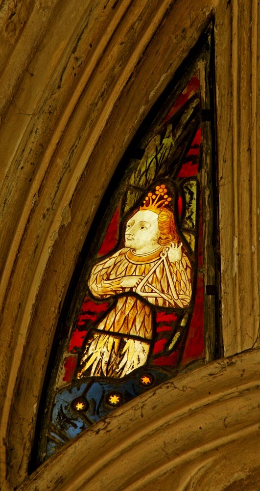 Window depicting a musician angel with a triangle