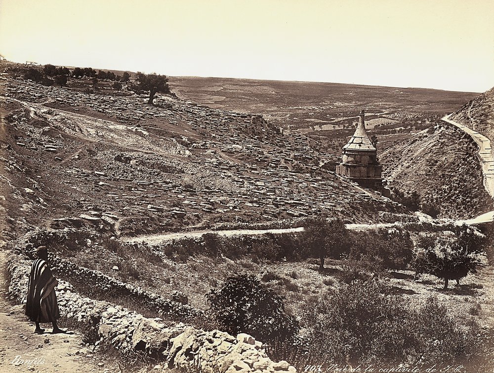 Panoramic view of the Valley of Cedron or Josafat, with the Tomb of Absalom, on the outskirts of Jerusalem. A man is looking at the view from the street by Félix Bonfils