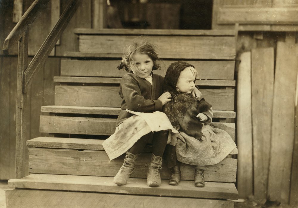 Portrait of Young Girl Taking Care of Baby Sister While Rest of Family Is Working at Local Cannery, Bayou La Batre, Alabama, USA, c. 1911 by Lewis Wickes Hine