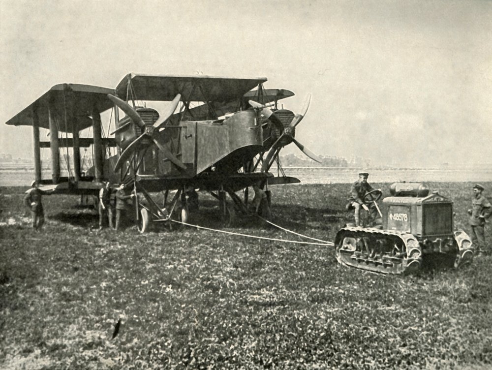 A Small Motor Tractor Getting a Huge R.A.F. Bombing Machine into Position