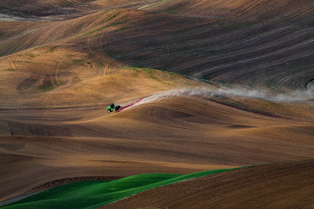 Tractor In Rolling Fields by Chuanxu Ren