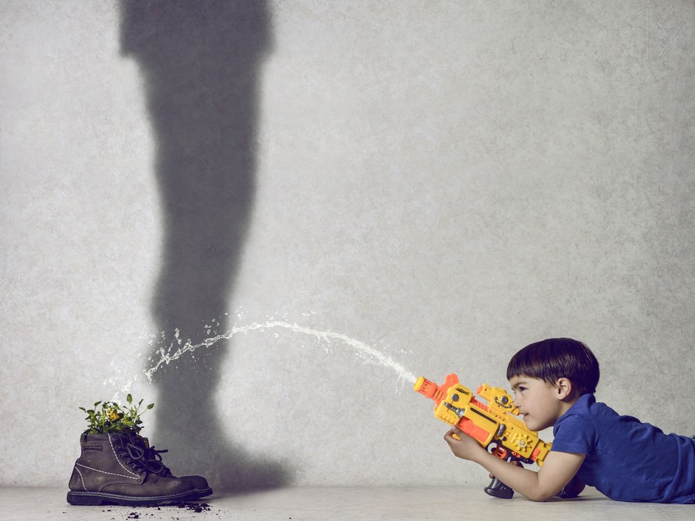Boy Waters Plant Shadow by Karim Aboukelela