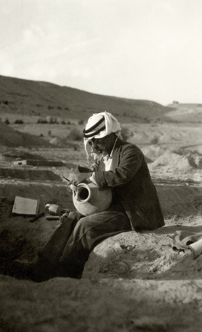John Garstang at Jericho studying a Middle Bronze Age jug from c.1800 BC by English Photographer