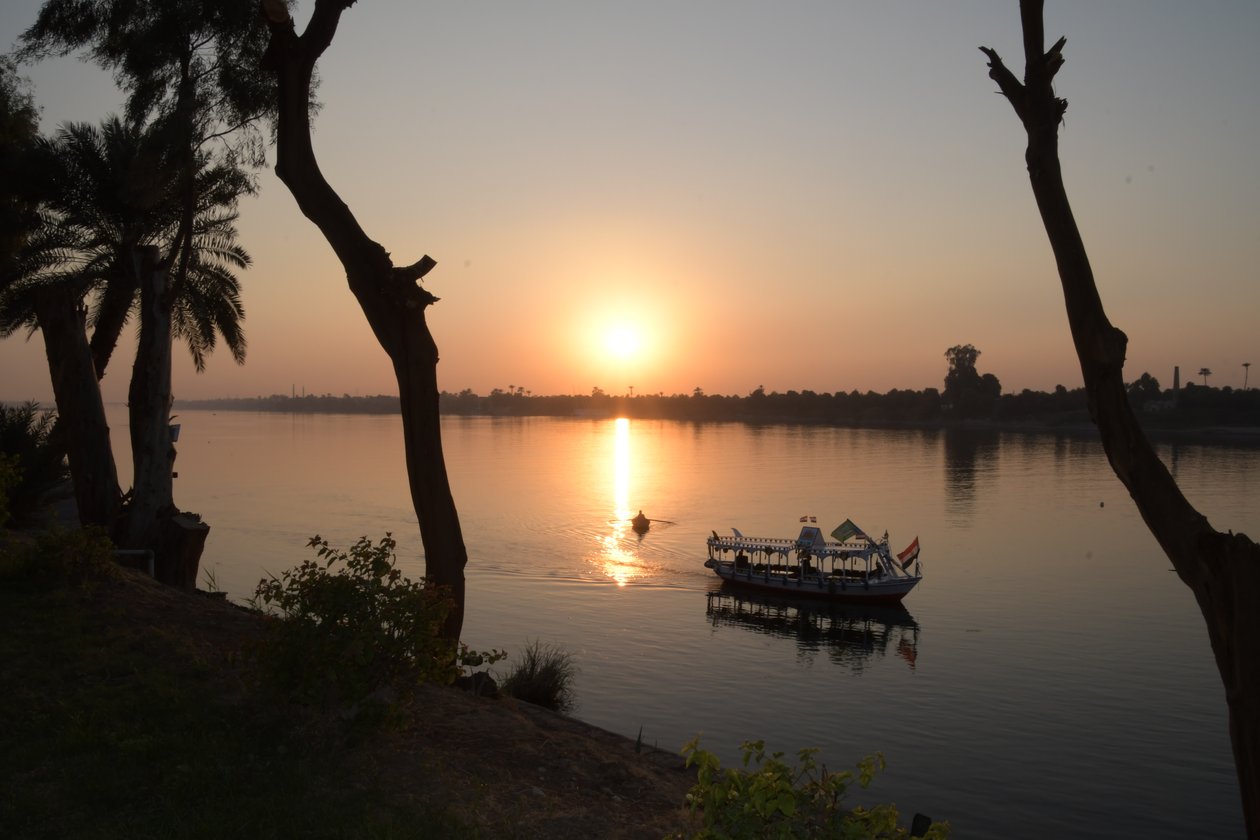 Golden Sunset Reflections on a Tranquil River by Albert Mansour