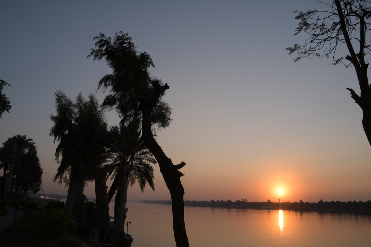 Golden Sunset Reflections on a Tranquil River by Albert Mansour
