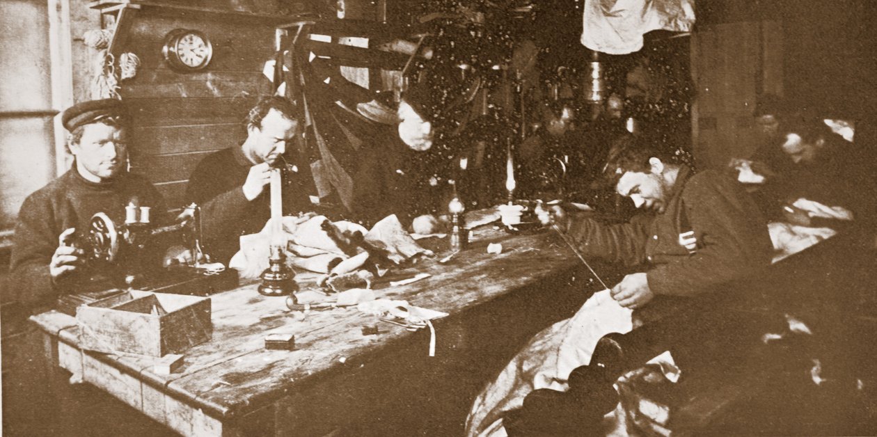In the Hut during Mid-Winter, the Men Engaged in Sewing Furs for Clothing to be Used in Springtime Sledging, pub. London 1907 by Anthony Fiala