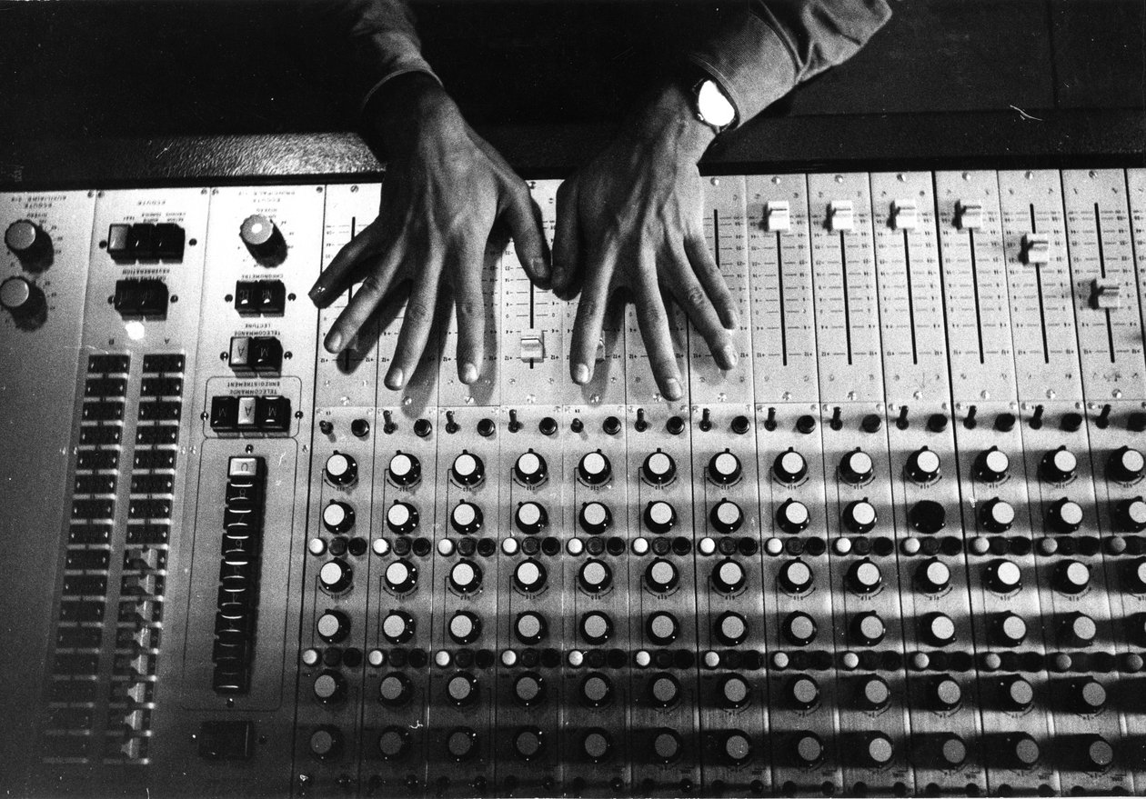 Hands on the mixing console by Bernard Perrine