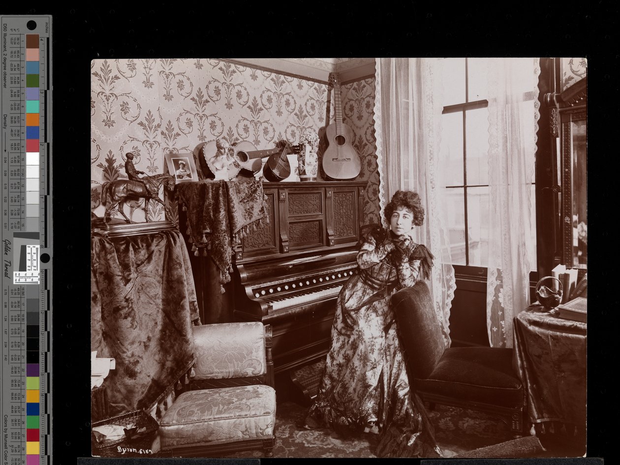 Anita Chartres sitting at a player piano, c.1898 by Byron Company