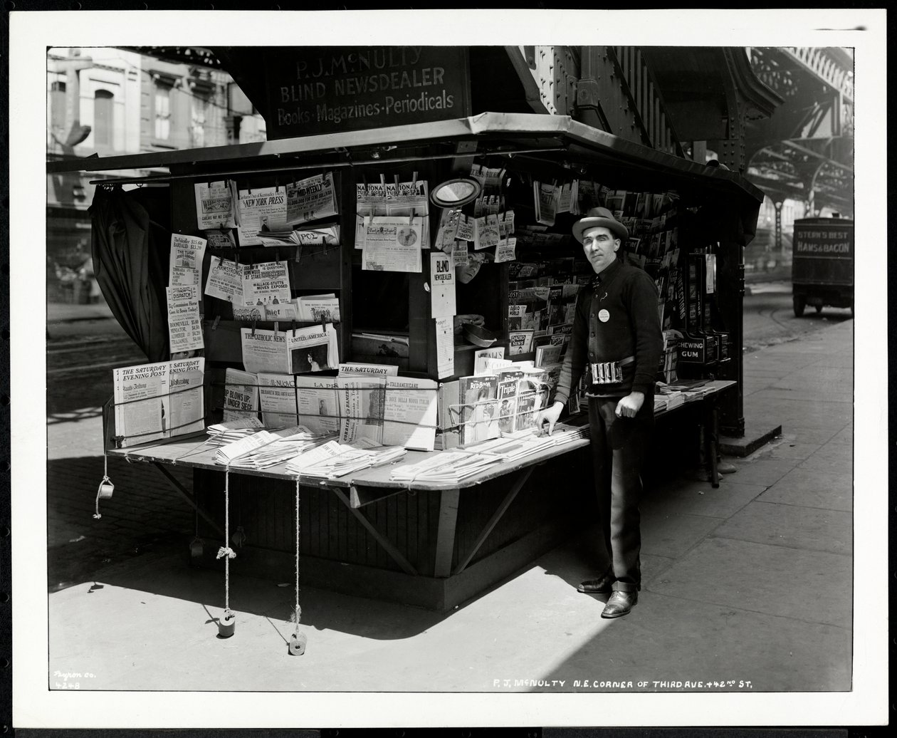 Blind news dealer P.J. McNulty at his stand at the north east corner of 3rd Avenue and 42nd Street, New York, 1926 by Byron Company