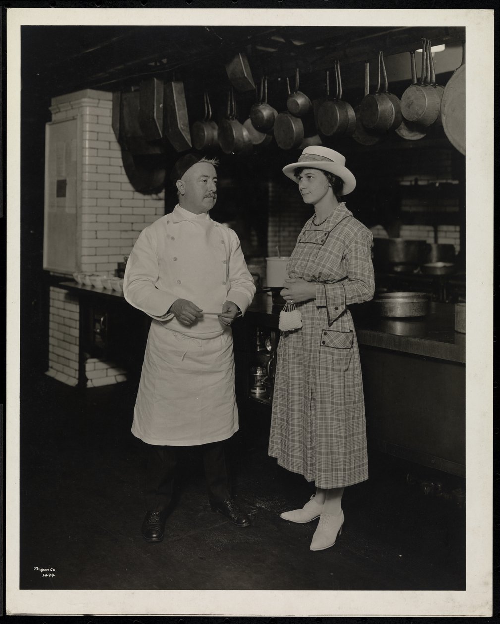 Chef Leoni and Miss Selley of Toronto in the Kitchen of the Hotel Commodore by Byron Company