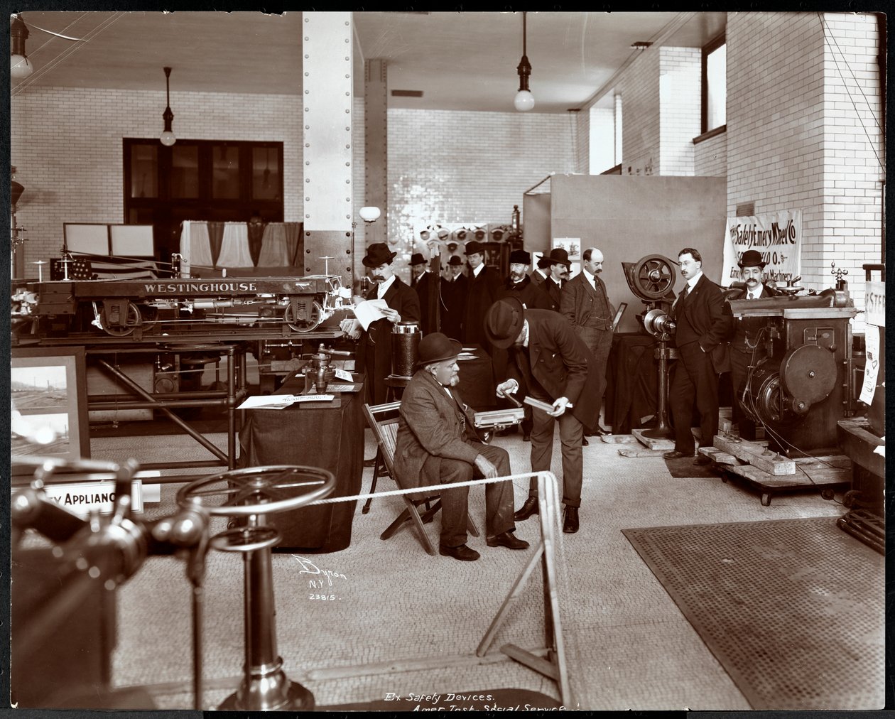 Men at an exhibit of safety devices at the American Institute of Social Service, New York by Byron Company