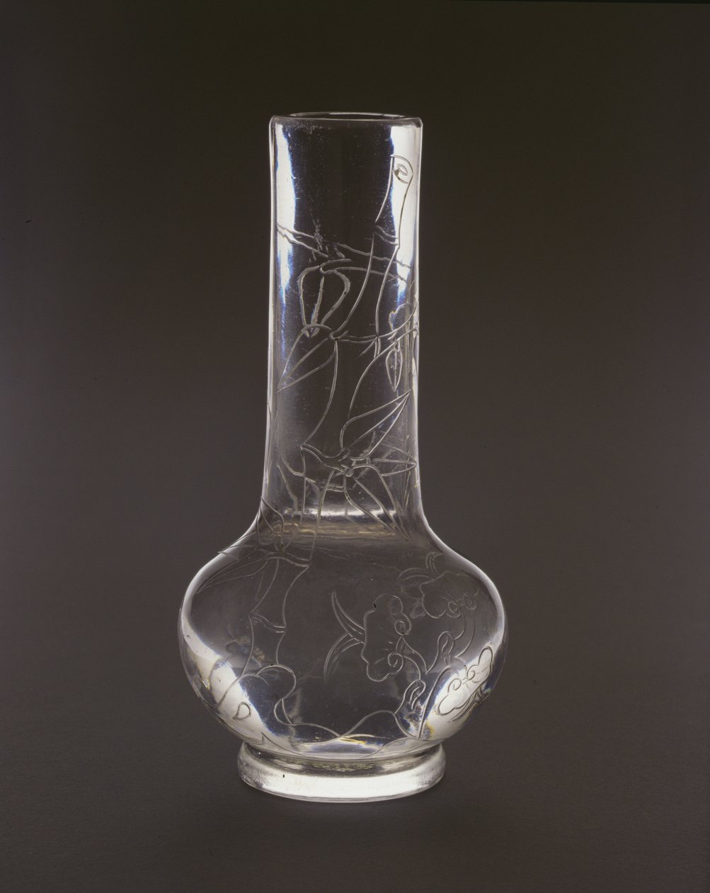 Bottle engraved with bamboo, lingzhi fungus plants and rocks, Qianlong mark and period by Chinese School