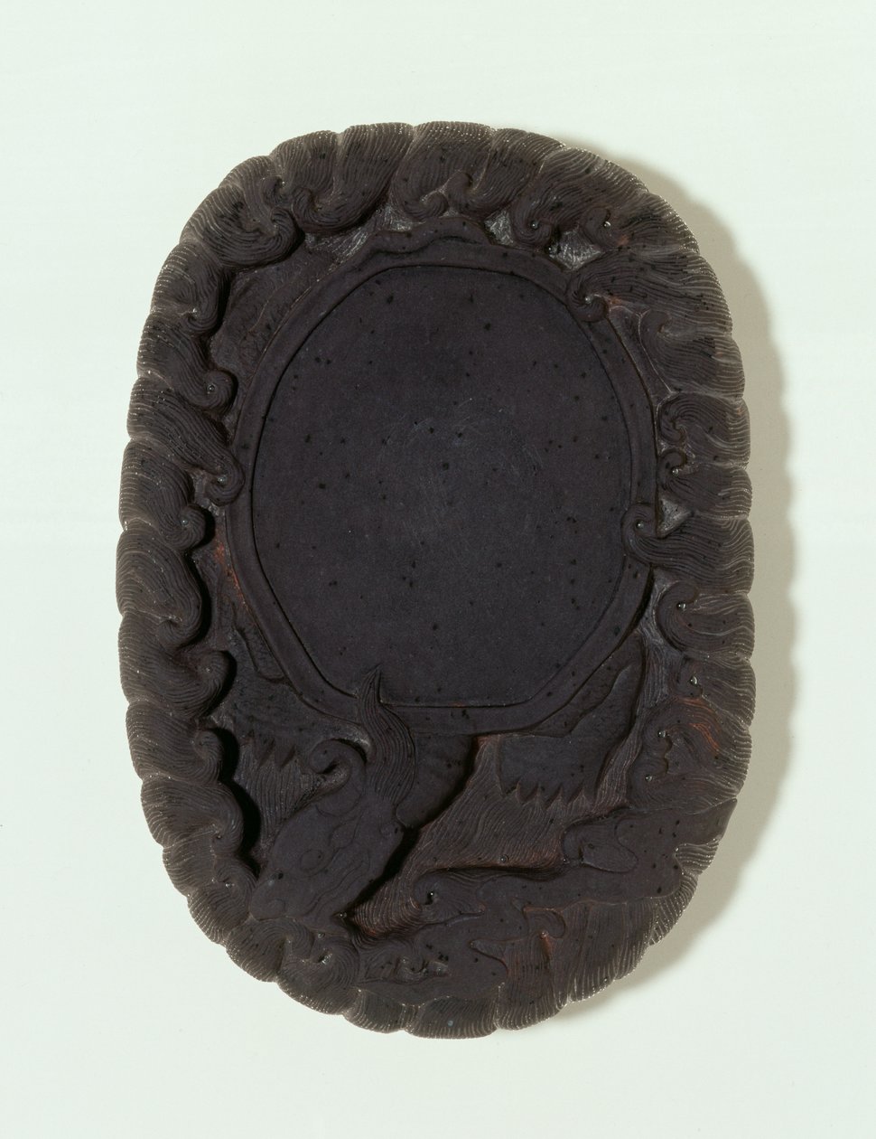 Inkstone carved as the large mythical Lo-shu tortoise among waves by Chinese School