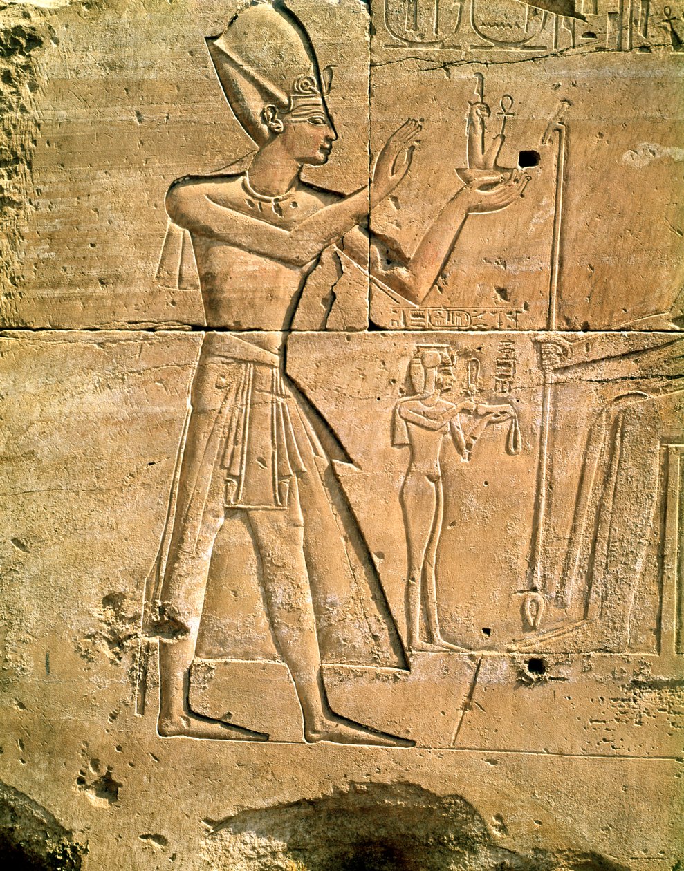 Relief depicting Tuthmosis III making an offering to a seated god by Egyptian 18th Dynasty