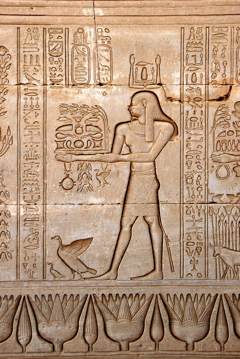 Egyptian antiquity: representation of a man bringing offerings to the goddess, Temple of Hathor, Denderah, Egypt - Egyptian civilization: a man carrying offerings to the goddess Hathor, carved on the wall of Hathor Temple (or Temple of Tentyra) in Denderah by Egyptian Ptolemaic Period
