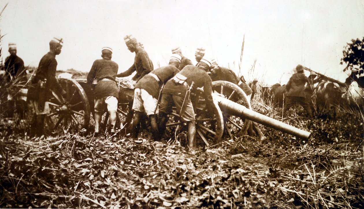Askaris getting field gun into position, East African campaign by English Photographer