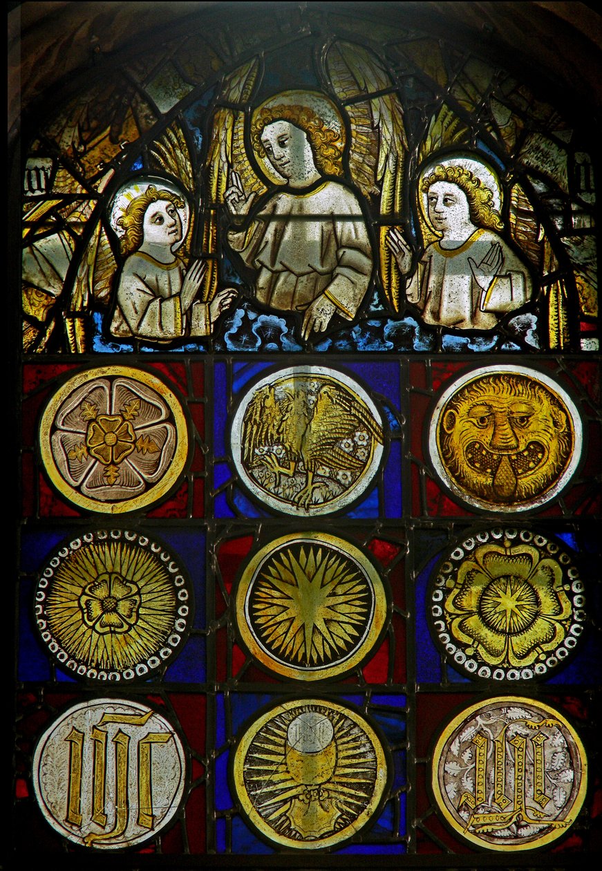 A panel in the east window depicting angels above 9 roundels with sunbursts, roses, a leopard
