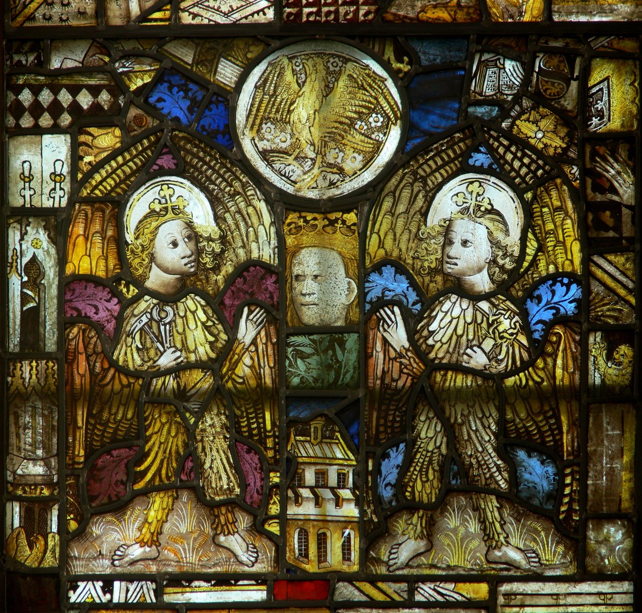 A panel in the east window depicting feathered angels with Passion Instruments and St John