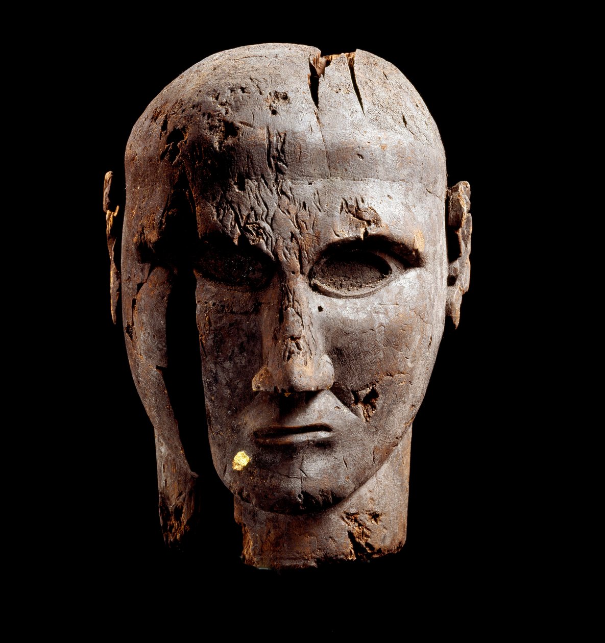 Head of a man, wood sculpture with trace of gold, 7th century BC by Etruscan