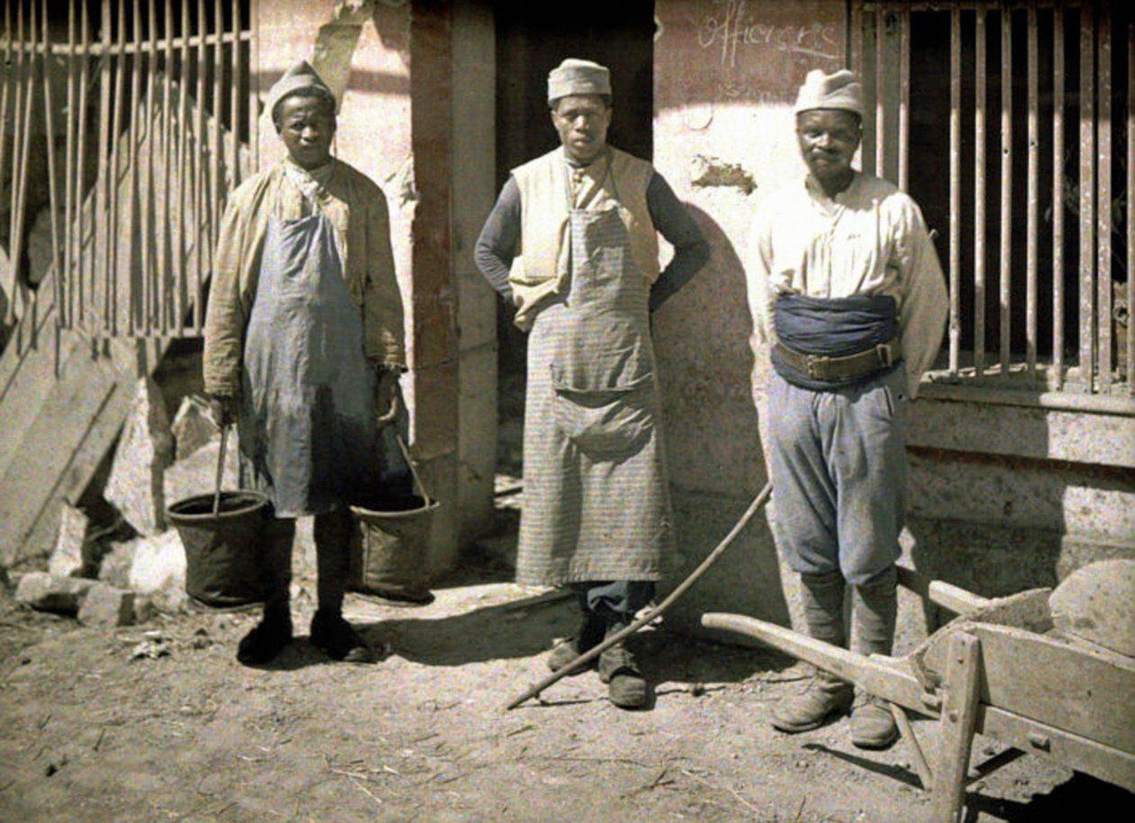 Three Workers from Senegal in Front of a House, Soissons, Aisne, France, 1917 by Fernand Cuville