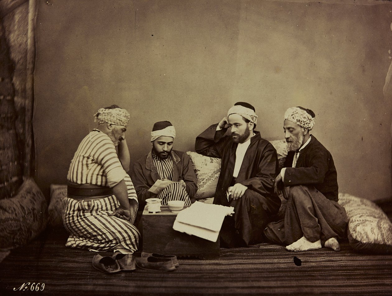 Album Damas et Baalbek: A group of Syrians sitting around a table by Félix Bonfils