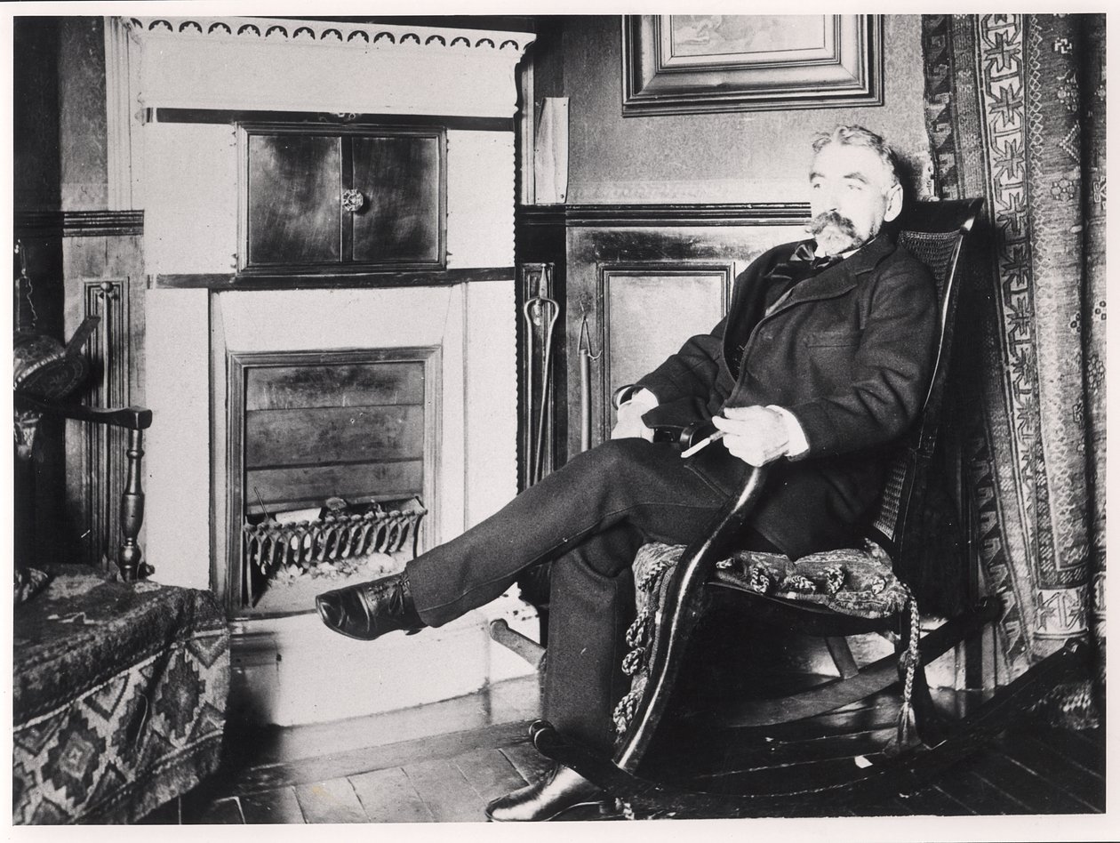 Stephane Mallarme (1842-98) seated by the fireplace at his home on Rue de Rome, Paris by French School