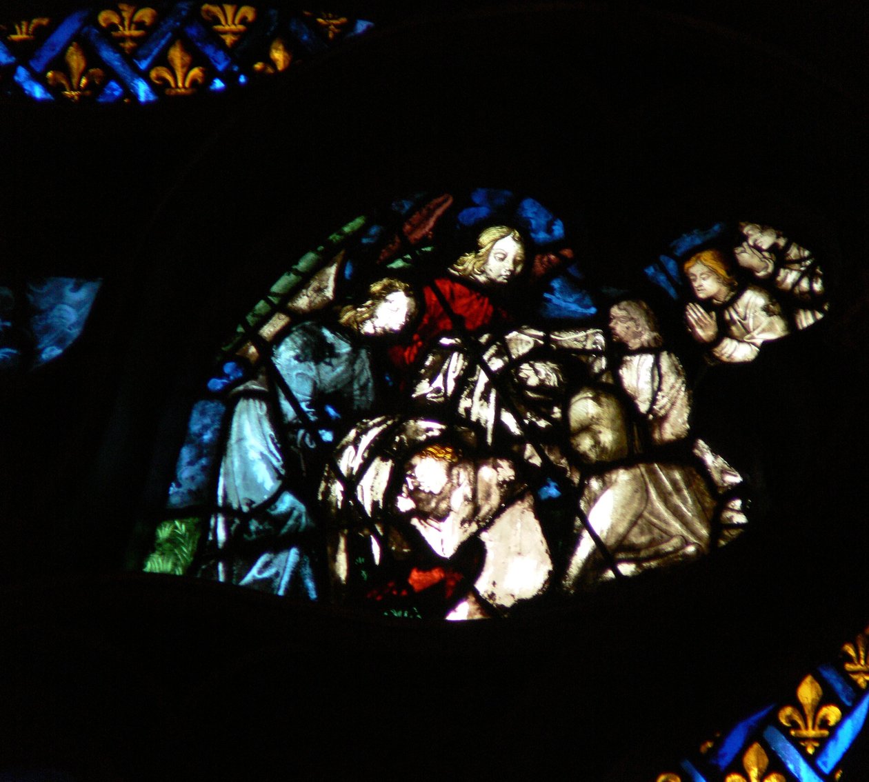 The west rose window depicting a scene from the Book of Revelation: Souls being arrayed in white robes by angels by French School