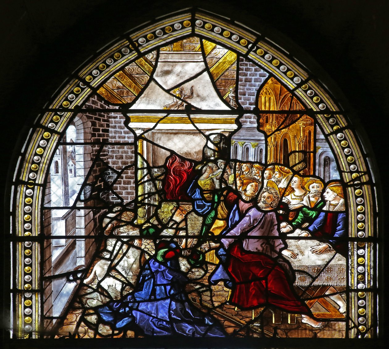 Window depicting St Thomas in India is invited to the wedding of Pelagius, is beaten by a servant who is in turn eaten by a lion. A dog brings in the servant