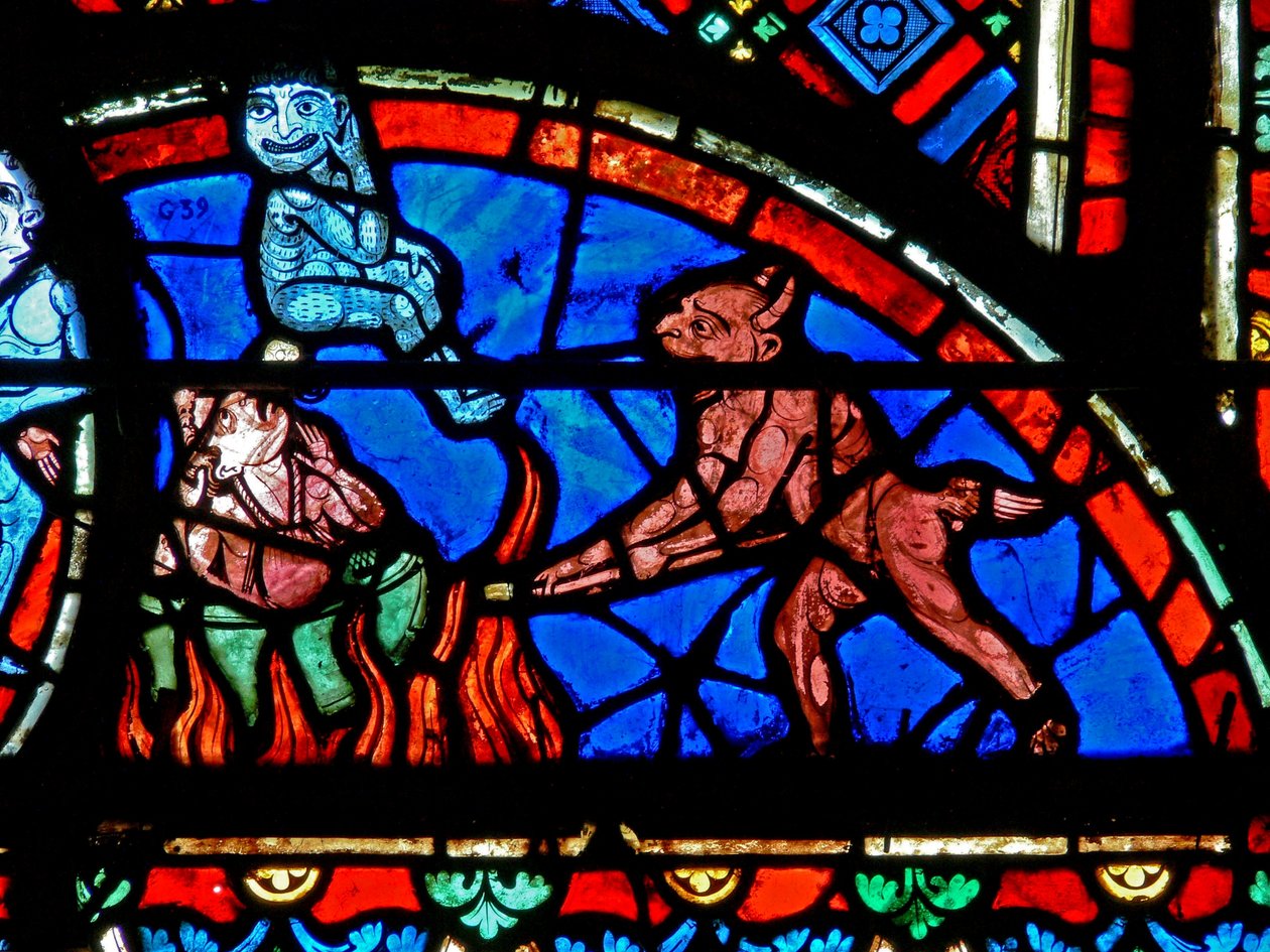 Window depicting an impenitent being tormented by demons