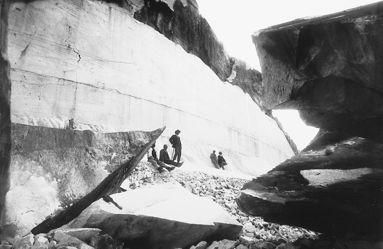Some men sitting along the walls of a marble quarry, in the Apuan Alps by G. Armani