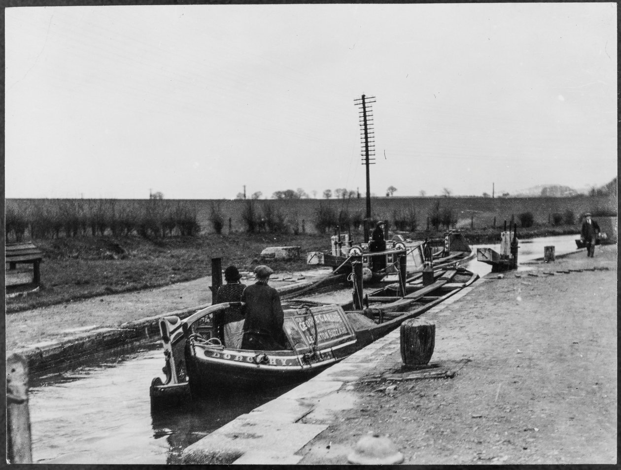 Two canal barges passing through a lock on the Grand Union Canal near Marsworth by George R. Long