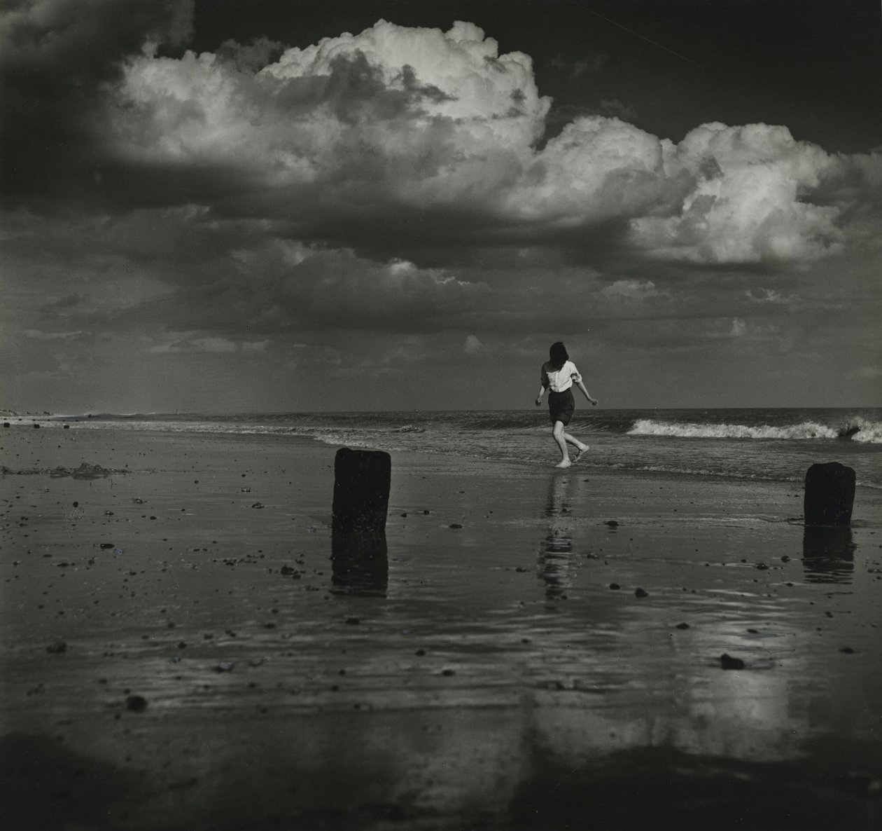 Kid playing with the waves at the beach by Godfrey Macdominic