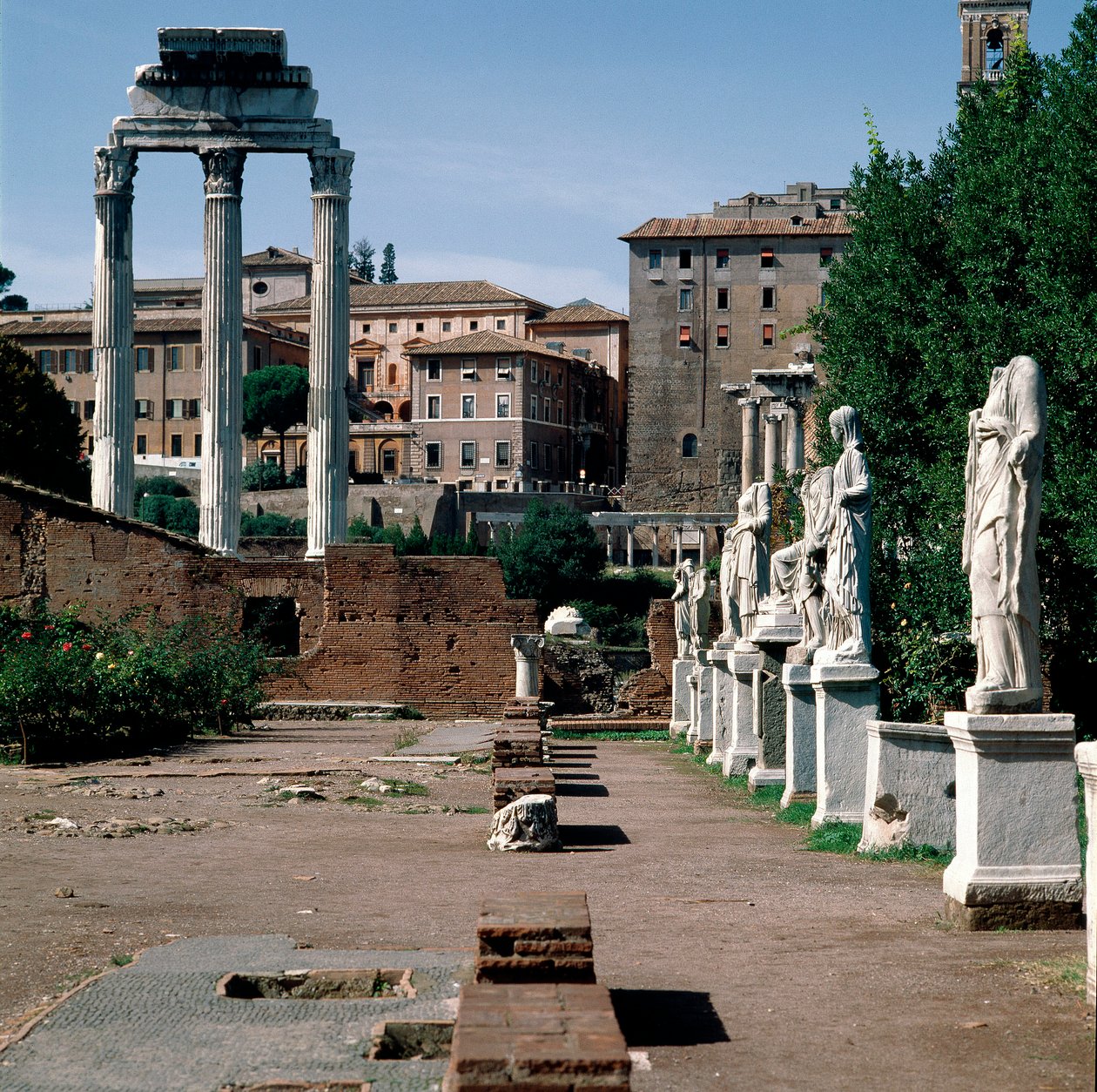 Roman Forum: statues of vestals. House of vestals (Casa delle Vestali or Atrium Vestae). On the left, the Greek temple of Dioscures (or temple of Castor and Pollux) (5th century BC). Rome by Greek or Roman