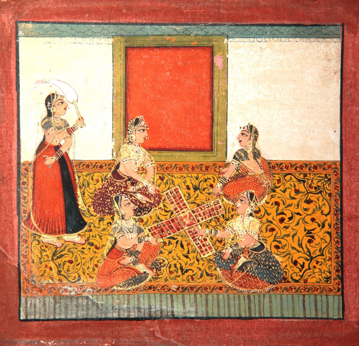 Women playing Parcheesi, seated on a yellow patterned floor spread by Indian School