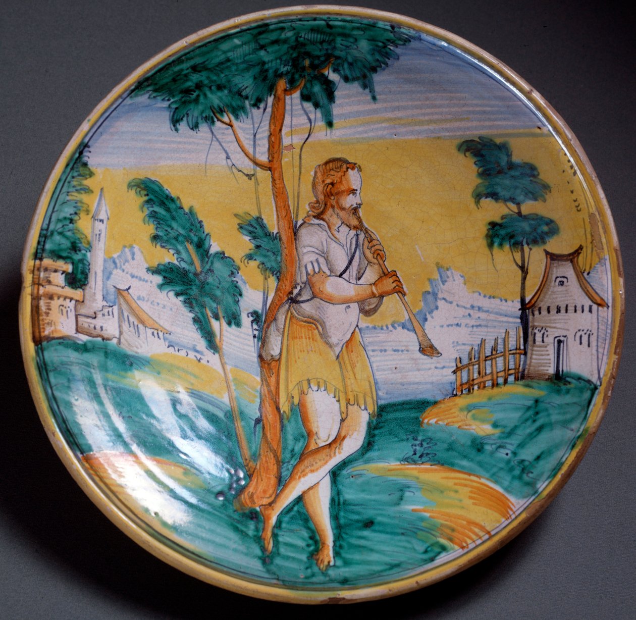 Plate decorated with a flute player, end of 16th century, Viterbo, Italy by Italian School