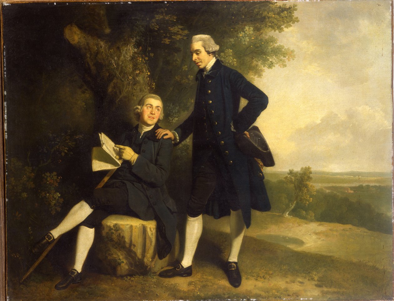 Double Portrait of Thomas Somers Cocks and Richard Cocks of Castleditch, Both Small Full-Length, the Former in a Blue Coat and Waistcoat Holding a Black Tricorn, the Latter Seated in a Blue Coat and Waistcoat Holding a Manuscript, in a Landscape by John Hamilton Mortimer