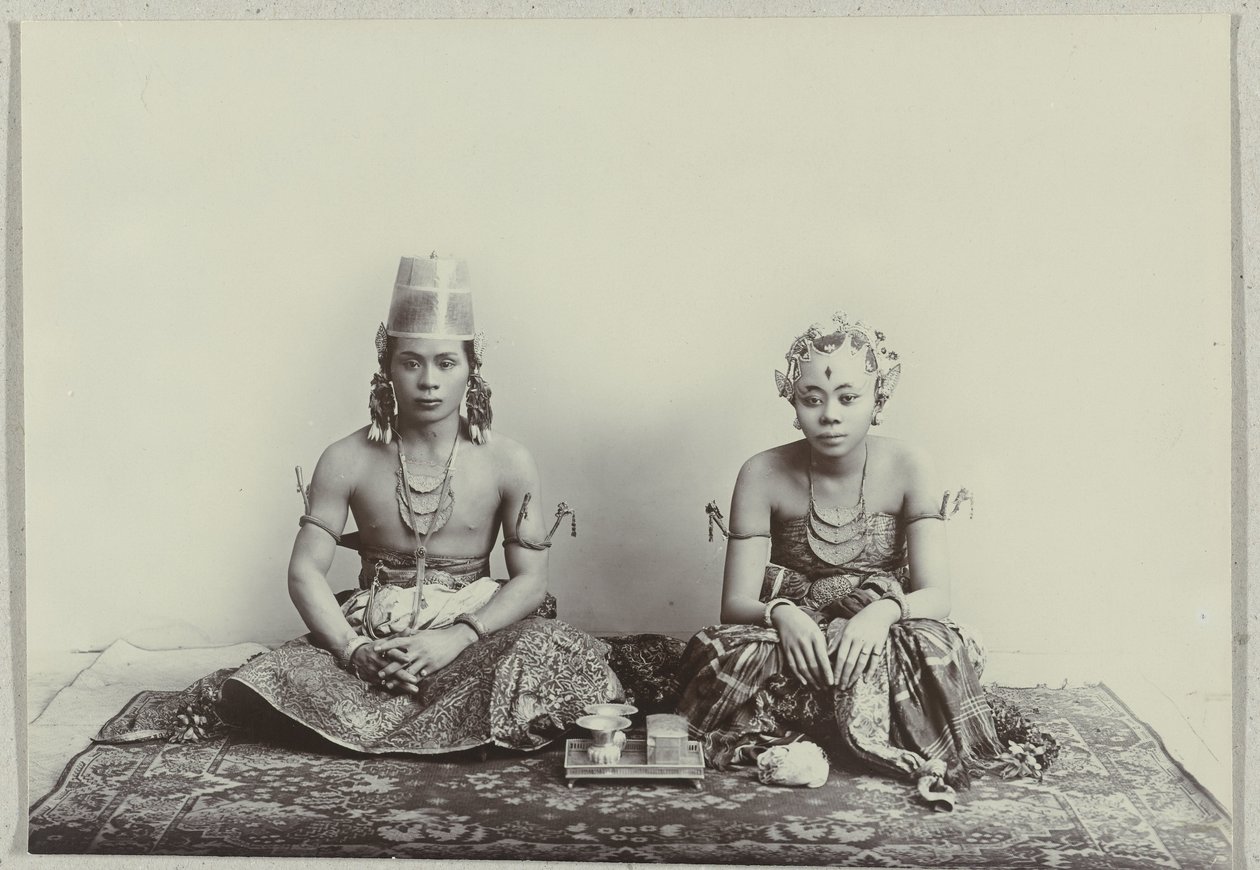 Studio Portrait of a Seated Young Javanese Man and Woman Wearing a Batik Sarong by Kassian Cephas