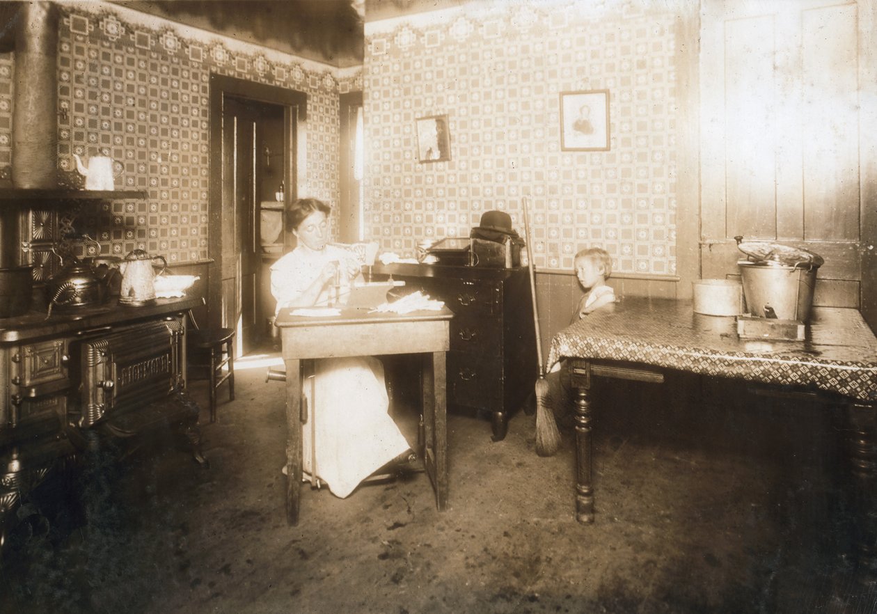 Woman inserting bristles into tooth brushes in her kitchen, c.1912 by Lewis Wickes Hine