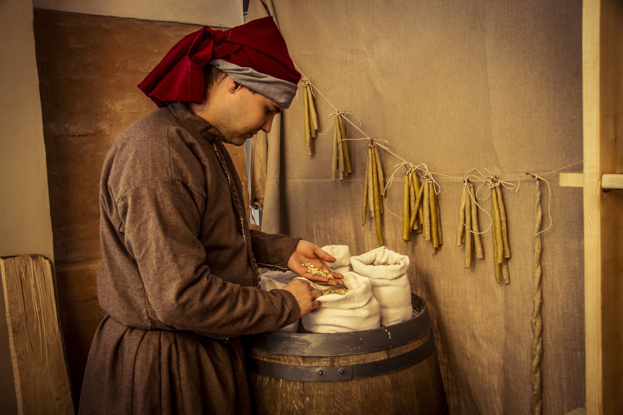 Historical reenactment: Candles and sacks of wheat, rye and barley in the apothecary of Diotaiuti, Imola, Italy, mid-14th century by Unbekannt Unbekannt