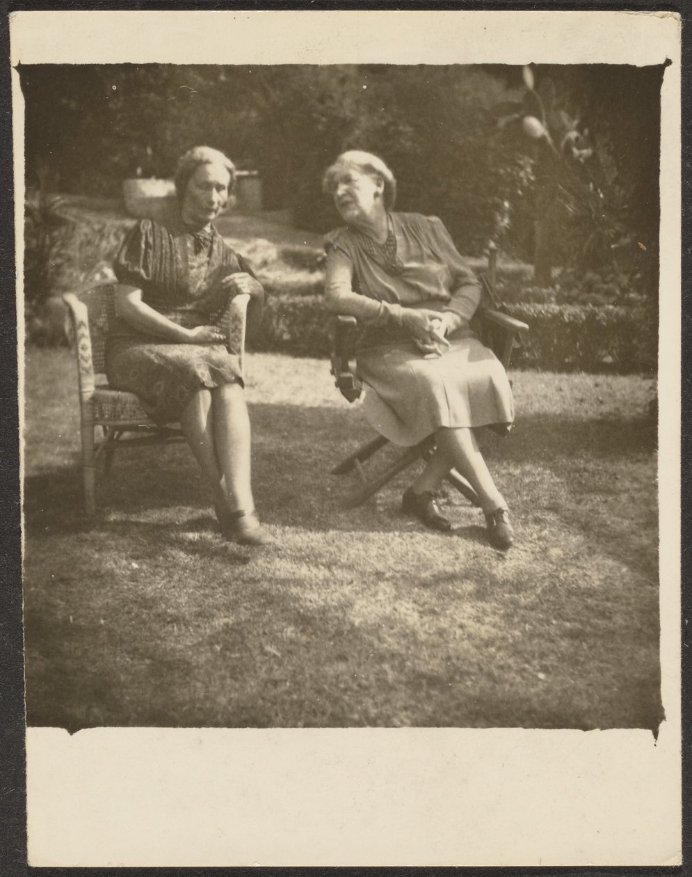 [Two Women Seated in Lawn Chairs] by Louis Fleckenstein