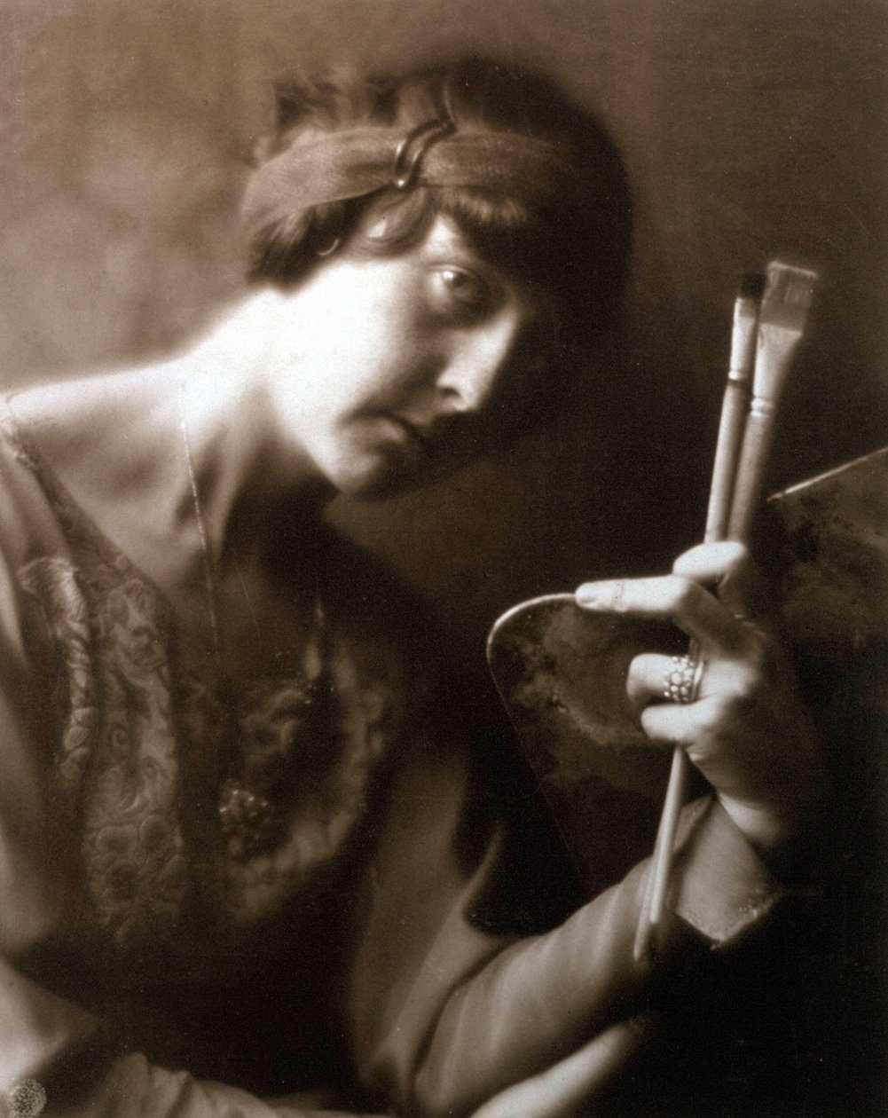 Half-length portrait of the painter Elisabeth Chaplin. She is holding two brushes and a palette in her left hand by Mario Nunes Vais