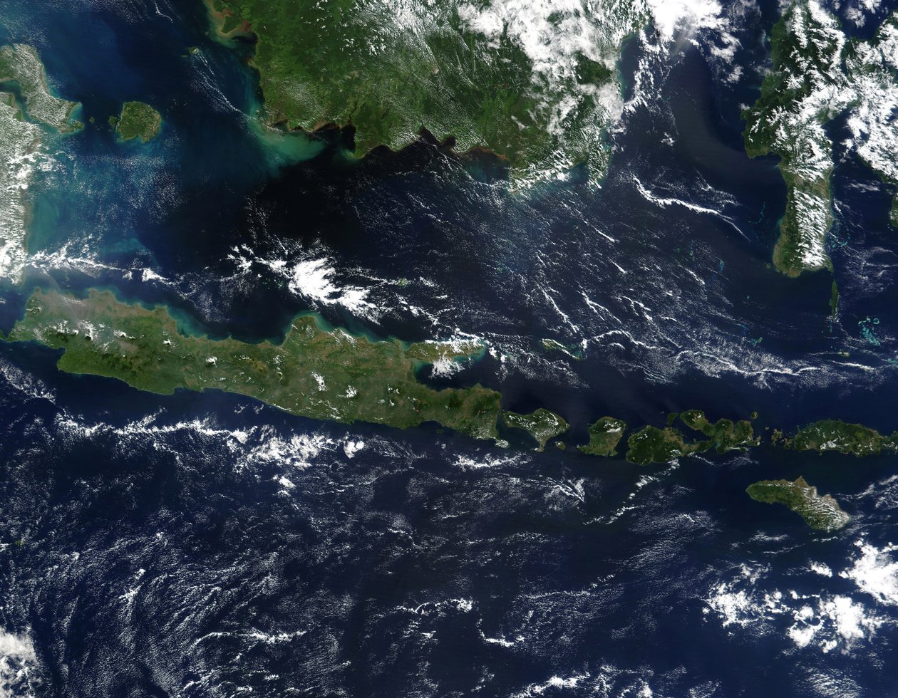 True-color satellite image of Indonesia mid-May 2002. As burning season was not fully underway in the region, skies over the island of Borneo, Malaysia at its northwest coast, are comparatively clear by National Aeronautics and Space Administration National Aeronautics and Space Administration