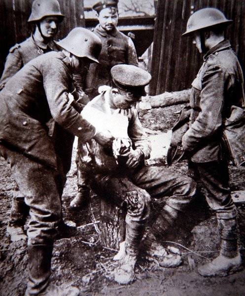 WWI German medical orderly tending a wounded British soldier on the Western Front by Photographer German