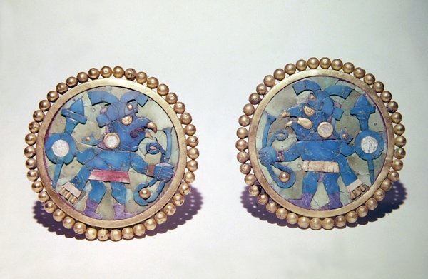 Ear disks decorated with bird-headed warriors carrying shields, spears ...