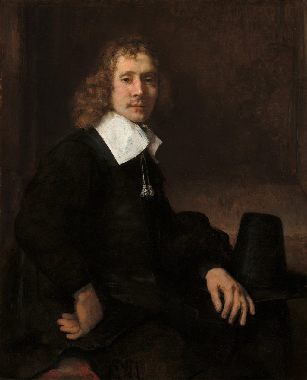 A Young Man Seated at a Table (possibly Govaert Flinck) by Rembrandt van Rijn