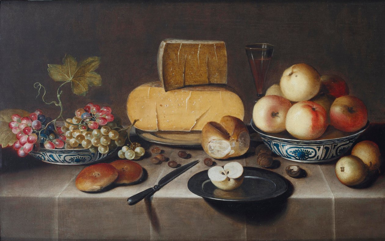 Cheese on a Silver Plate, Red and White Grapes and Apples in Porcelain Wanli Bowls, Bread Rolls, a Knife and a Sliced Apple on a Plate, All on a Draped Table by Roloef Koets